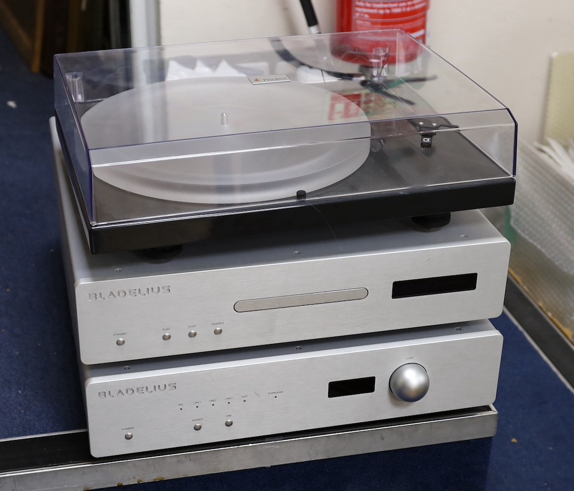 A Bladelius pre main amplifier, model TYR, and CD player, model SYN, a Pro-Ject Xpression III turntable, pair of IMF speakers and a Trichord Dino power supply.